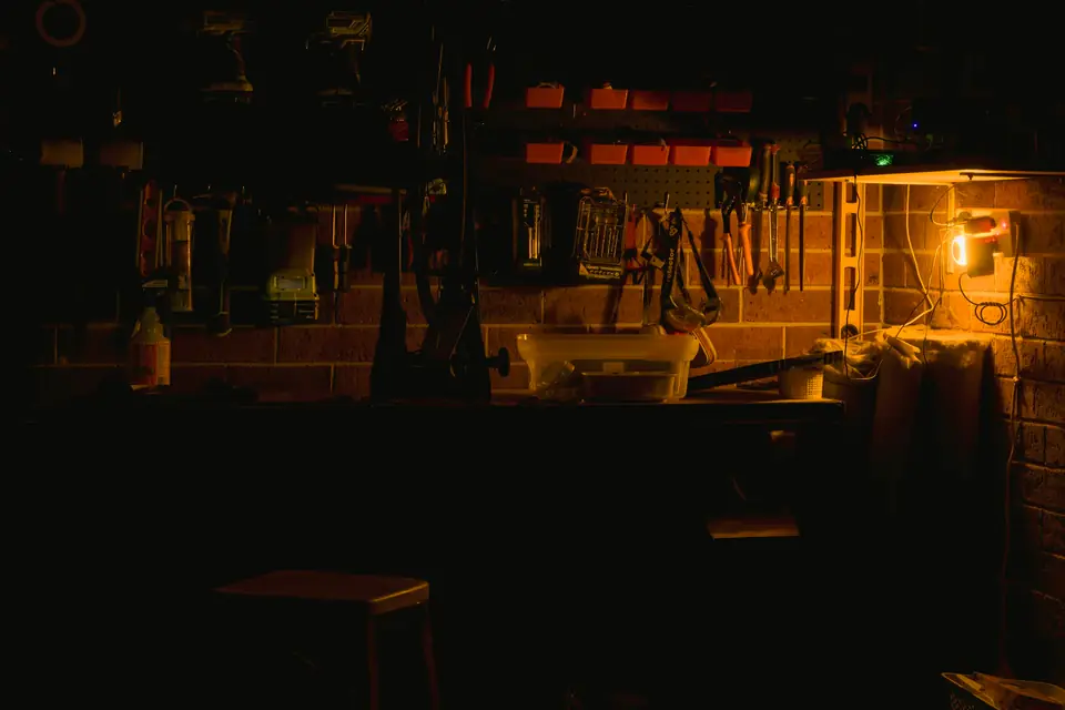 The workbench lit by one lamp at night