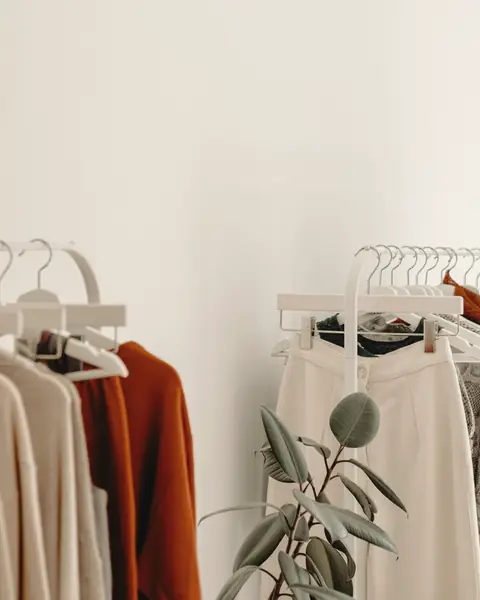 Clothing racks with neutral-toned garments in a quiet boutique