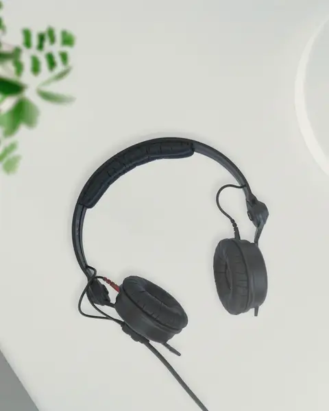Black wired headphones on a white desk
